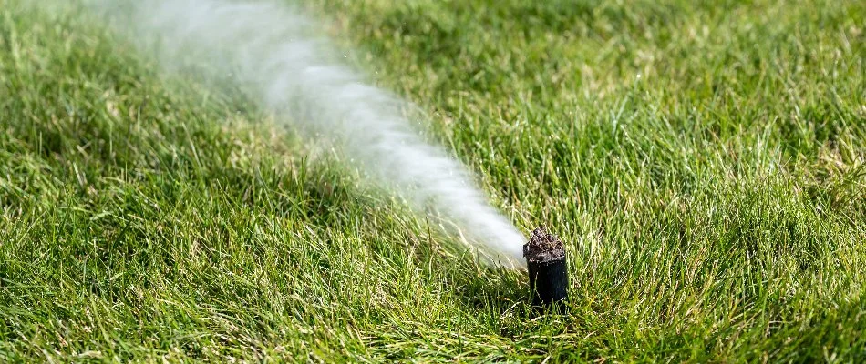 Blowing water out of an irrigation sprinkler head in Upper Arlington, OH.