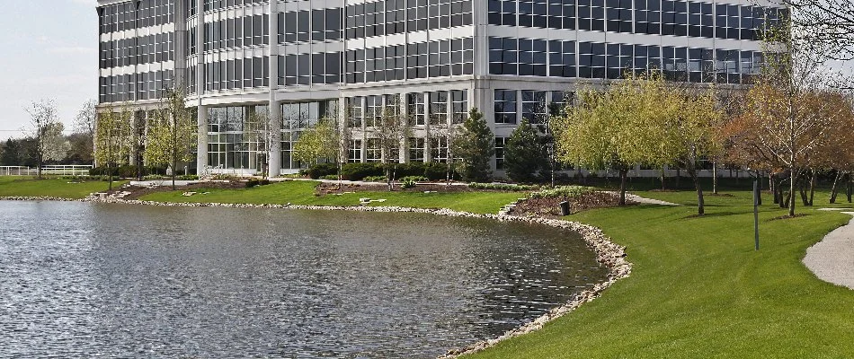 Commercial property in Upper Arlington, OH, with grass, trees, and pond.