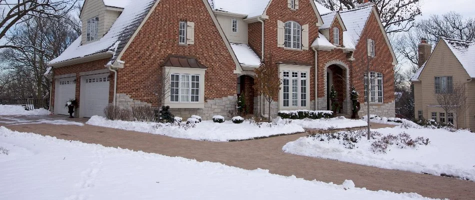 Front yard in Upper Arlington, OH, with snow and a cleared driveway.