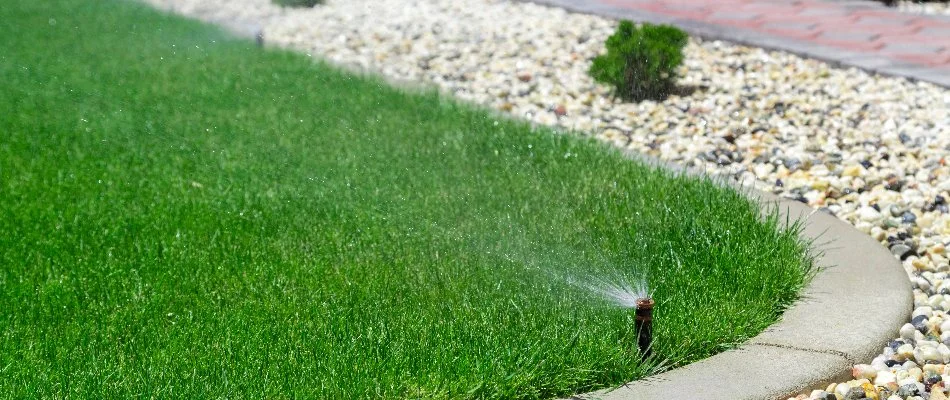 Green grass in Upper Arlington, OH, with sprinklers along the border.
