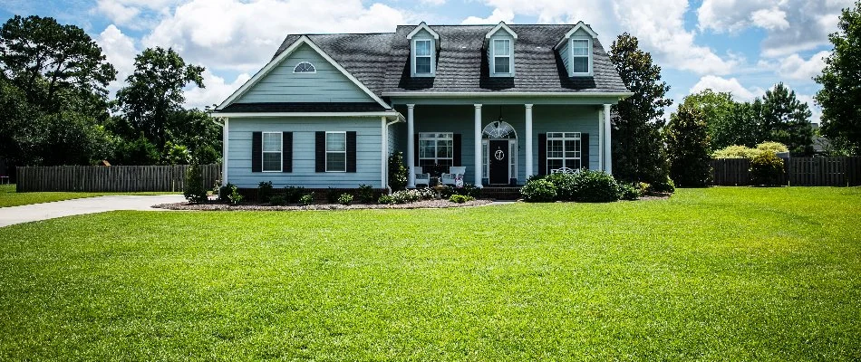 House in Upper Arlington, OH, behind lush green grass.