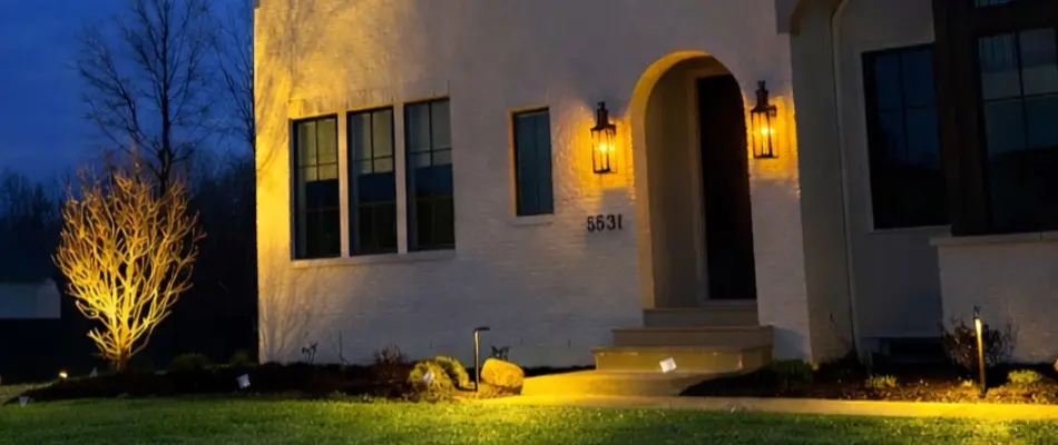 Facade of a house in Upper Arlington, OH, with outdoor lighting.