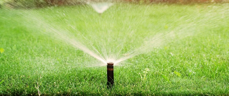 Irrigation sprinkler head watering green grass in Upper Arlington, OH.