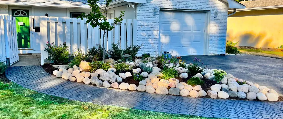 Landscape bed in Upper Arlington, OH, with rocks and plants.