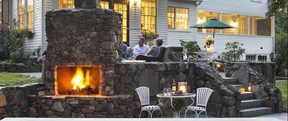 People behind an outdoor fireplace in Upper Arlington, OH.