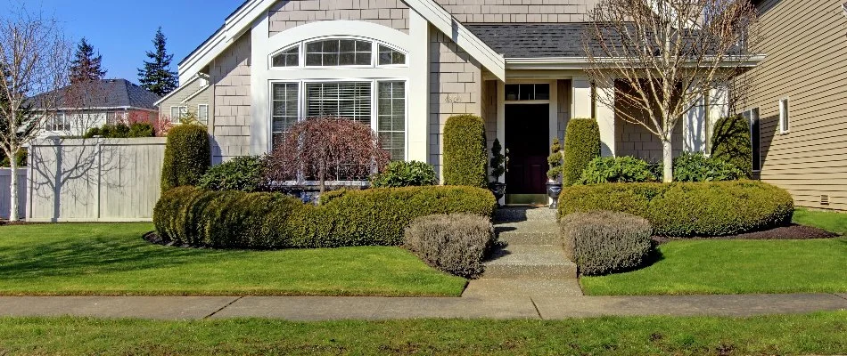 Yard in Upper Arlington, OH, with trimmed shrubs.